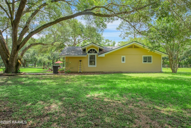 rear view of property with a lawn