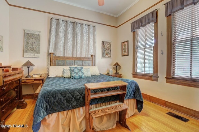 122 Lee St, New Iberia, LA 70560 - bedroom with wood finished floors, crown molding, baseboards, and ceiling fan