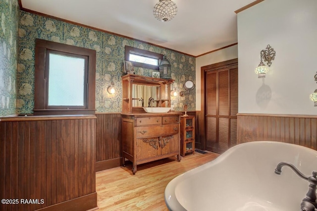 122 Lee St, New Iberia, LA 70560 - full bath featuring wainscoting, crown molding, a freestanding tub, vanity, and wood finished floors