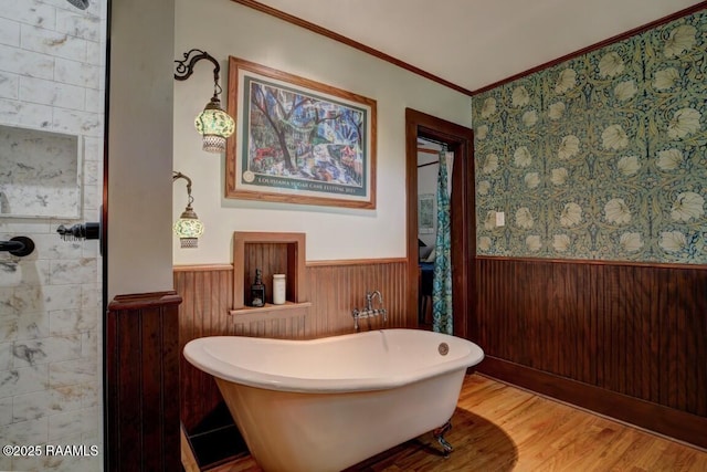 122 Lee St, New Iberia, LA 70560 - bathroom with wainscoting, ornamental molding, a soaking tub, wood finished floors, and wooden walls