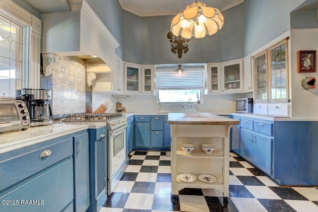122 Lee St, New Iberia, LA 70560 - kitchen with blue cabinetry, tile patterned floors, appliances with stainless steel finishes, tasteful backsplash, and white cabinetry