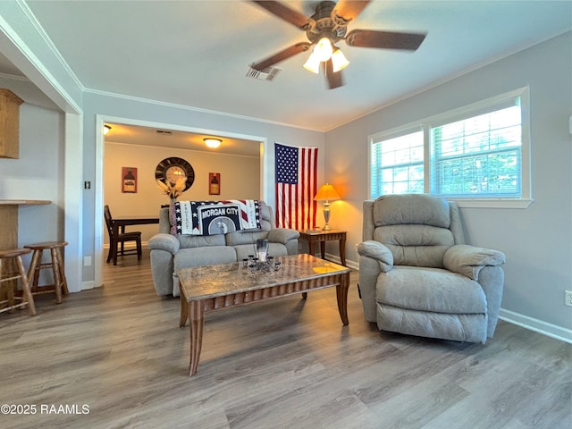 230 Glenwood Ave, Morgan City, LA 70380 - living area featuring light wood-style flooring, crown molding, ceiling fan, and baseboards
