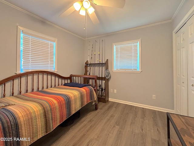 230 Glenwood Ave, Morgan City, LA 70380 - bedroom with wood finished floors, ornamental molding, a closet, a ceiling fan, and baseboards