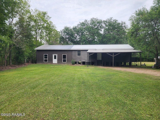 view of front of house featuring metal roof and a front lawn