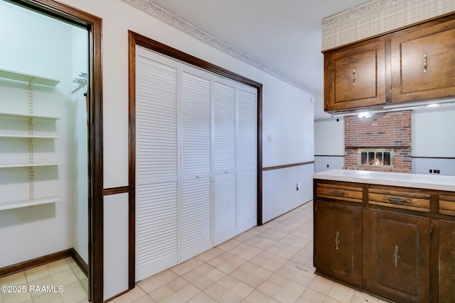 kitchen featuring light countertops and a fireplace