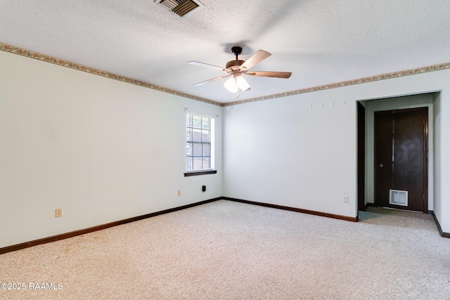 unfurnished room with a textured ceiling, visible vents, ceiling fan, and light carpet