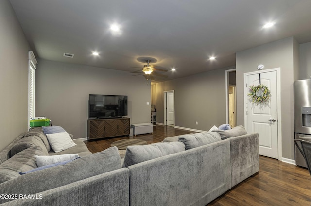 living area with dark wood-style flooring, a ceiling fan, visible vents, and recessed lighting