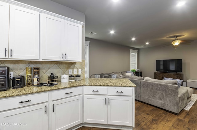 kitchen with a ceiling fan, recessed lighting, white cabinets, open floor plan, and tasteful backsplash