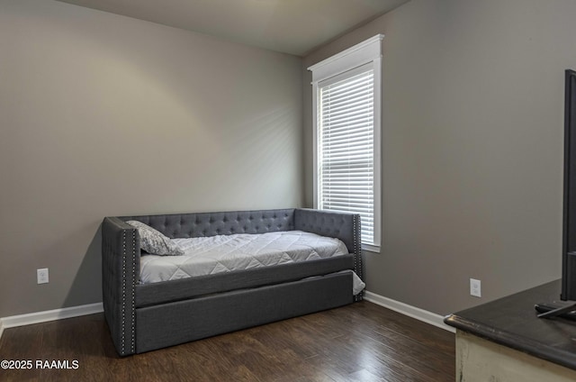 sitting room featuring dark wood finished floors, plenty of natural light, and baseboards