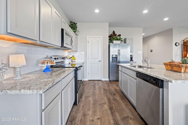 4058 Starling Pl, Jennings, LA 70546 - kitchen featuring a sink, dark wood-style floors, backsplash, appliances with stainless steel finishes, and recessed lighting