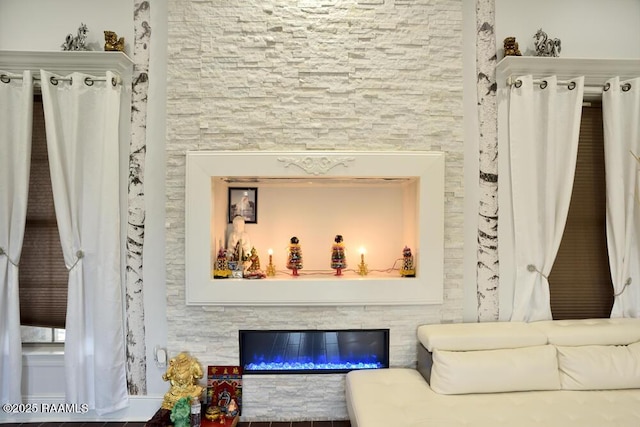 living room featuring a glass covered fireplace