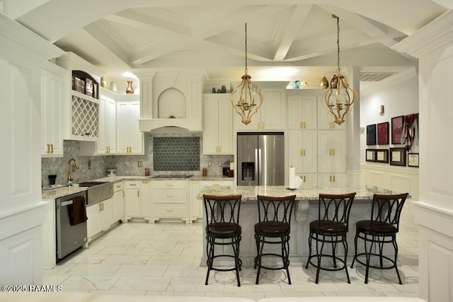 kitchen featuring appliances with stainless steel finishes, a sink, light marble finish flooring, a kitchen breakfast bar, and beam ceiling