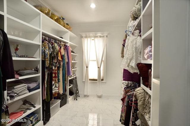walk in closet featuring marble look tiles
