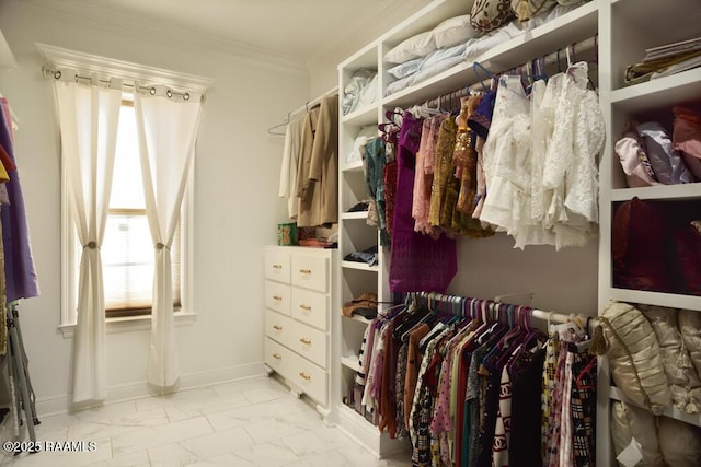 spacious closet featuring marble look tile flooring