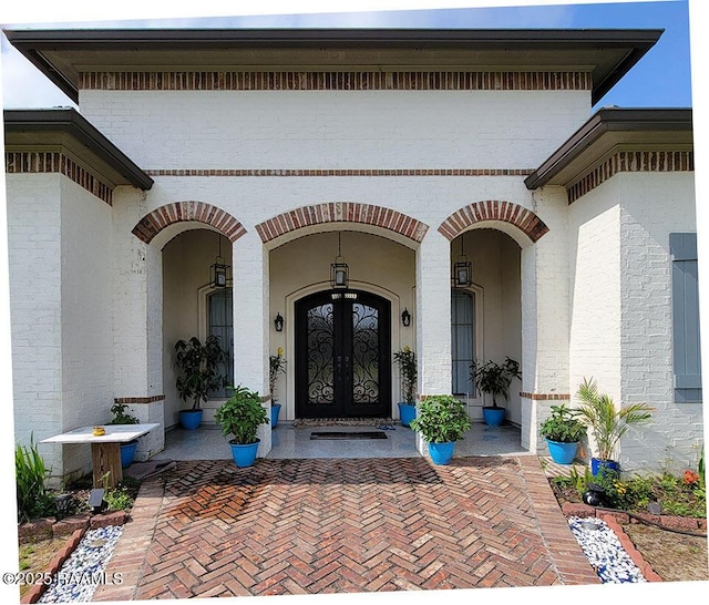 doorway to property with french doors and brick siding