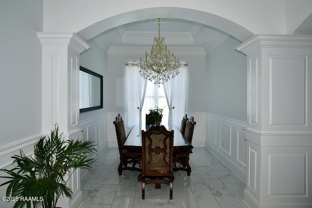 4300 Gerald James Dr, New Iberia, LA 70560 - dining area featuring a chandelier, plenty of natural light, light marble finish flooring, arched walkways, and a decorative wall