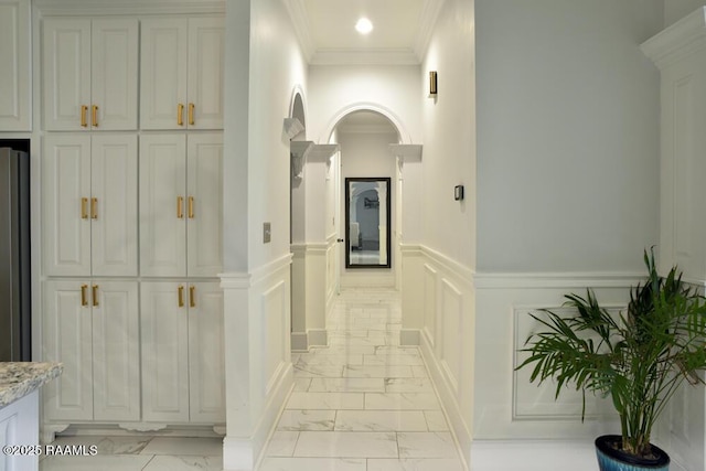 4300 Gerald James Dr, New Iberia, LA 70560 - hallway with light marble finish floors, ornamental molding, a decorative wall, wainscoting, and recessed lighting