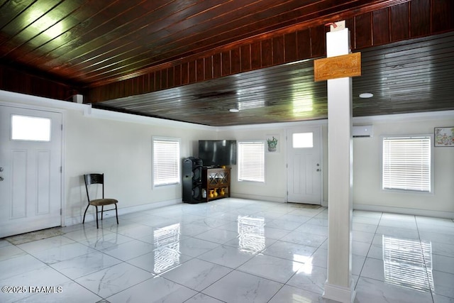 4300 Gerald James Dr, New Iberia, LA 70560 - entrance foyer featuring decorative columns, baseboards, light marble finish floors, and wood ceiling