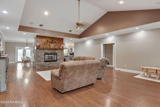 16634 W La Highway 330, Abbeville, LA 70510 - living room with a fireplace, baseboards, wood finished floors, ceiling fan, and lofted ceiling