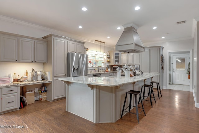 16634 W La Highway 330, Abbeville, LA 70510 - kitchen with appliances with stainless steel finishes, crown molding, a breakfast bar area, gray cabinets, and recessed lighting