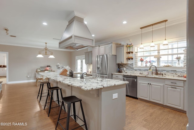 16634 W La Highway 330, Abbeville, LA 70510 - kitchen with appliances with stainless steel finishes, a sink, ornamental molding, a breakfast bar area, and decorative backsplash