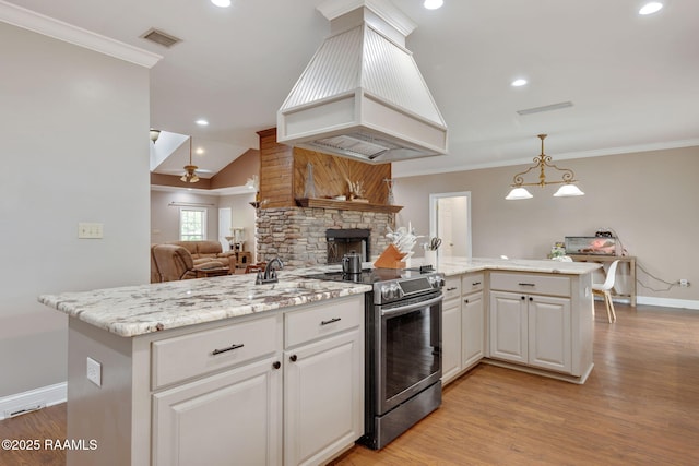 16634 W La Highway 330, Abbeville, LA 70510 - kitchen featuring stainless steel range with electric cooktop, custom exhaust hood, open floor plan, crown molding, and baseboards