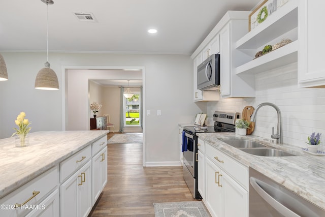 513 Emmeline St, New Iberia, LA 70563 - kitchen featuring appliances with stainless steel finishes, a sink, open shelves, decorative backsplash, and light wood-type flooring