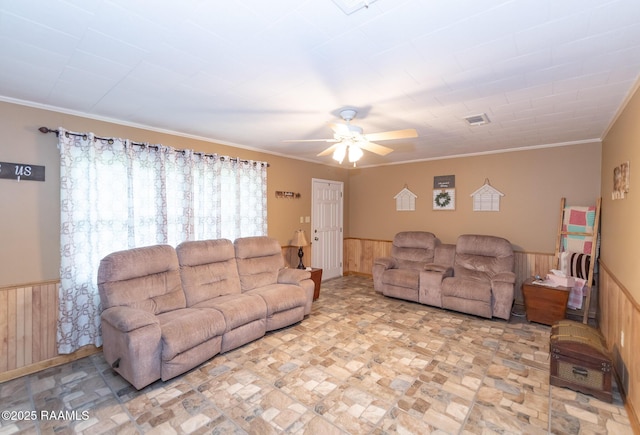 2405 S Chataignier Rd, Ville Platte, LA 70586 - living room with a wainscoted wall, a ceiling fan, wooden walls, and crown molding