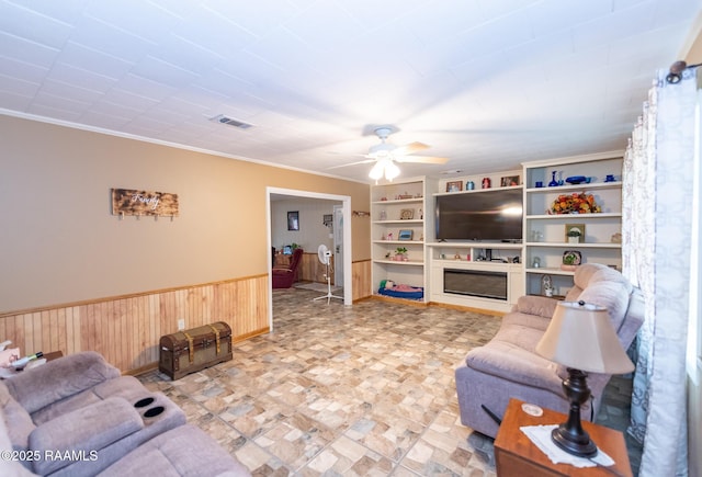 2405 S Chataignier Rd, Ville Platte, LA 70586 - living area with ceiling fan, a wainscoted wall, crown molding, and wood walls