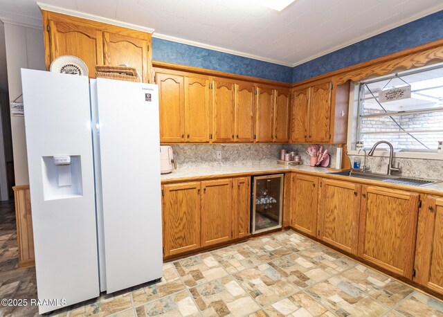 2405 S Chataignier Rd, Ville Platte, LA 70586 - kitchen featuring wine cooler, white refrigerator with ice dispenser, a sink, backsplash, and brown cabinetry
