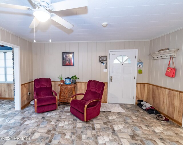 2405 S Chataignier Rd, Ville Platte, LA 70586 - entrance foyer with crown molding, wood walls, and a ceiling fan