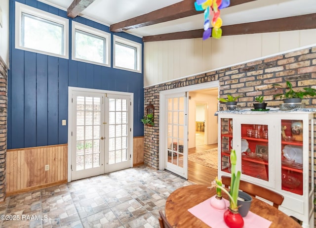 2405 S Chataignier Rd, Ville Platte, LA 70586 - foyer entrance with french doors, wooden walls, beam ceiling, and wainscoting