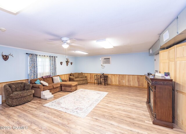 2405 S Chataignier Rd, Ville Platte, LA 70586 - living room featuring a wainscoted wall, ceiling fan, wood walls, light wood-style floors, and a wall mounted air conditioner
