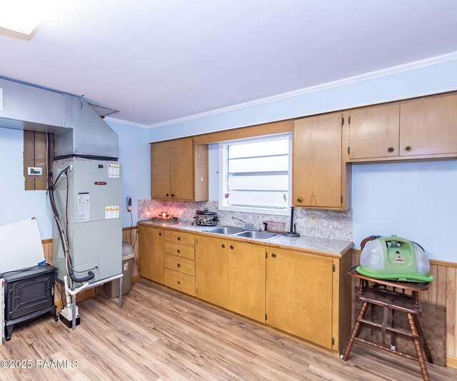 2405 S Chataignier Rd, Ville Platte, LA 70586 - kitchen with a sink, light countertops, light wood-style floors, decorative backsplash, and ornamental molding
