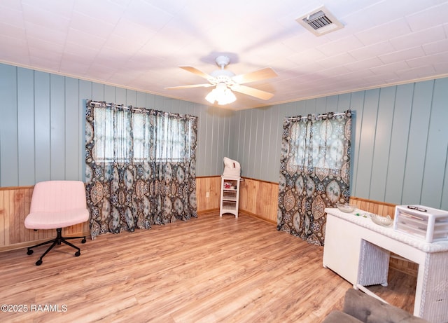 2405 S Chataignier Rd, Ville Platte, LA 70586 - misc room featuring wood finished floors, wood walls, a ceiling fan, and baseboards
