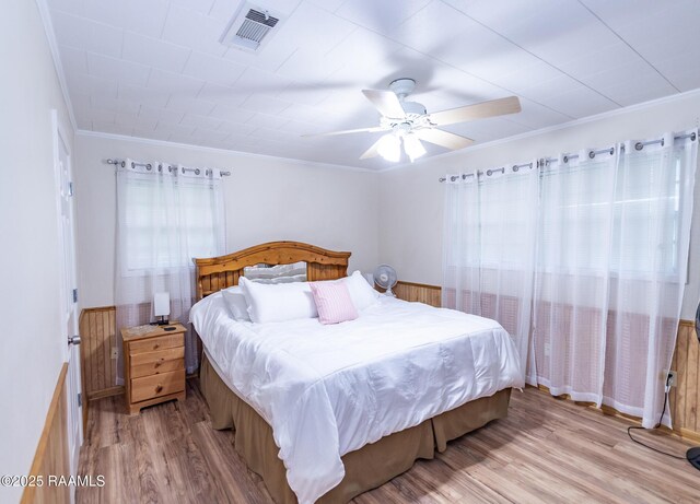 2405 S Chataignier Rd, Ville Platte, LA 70586 - bedroom with light wood finished floors, crown molding, and ceiling fan