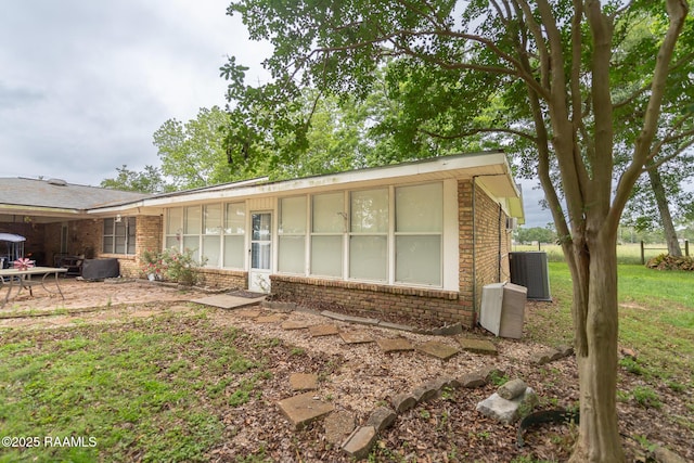 2405 S Chataignier Rd, Ville Platte, LA 70586 - single story home with brick siding, a patio, central air condition unit, and a front yard