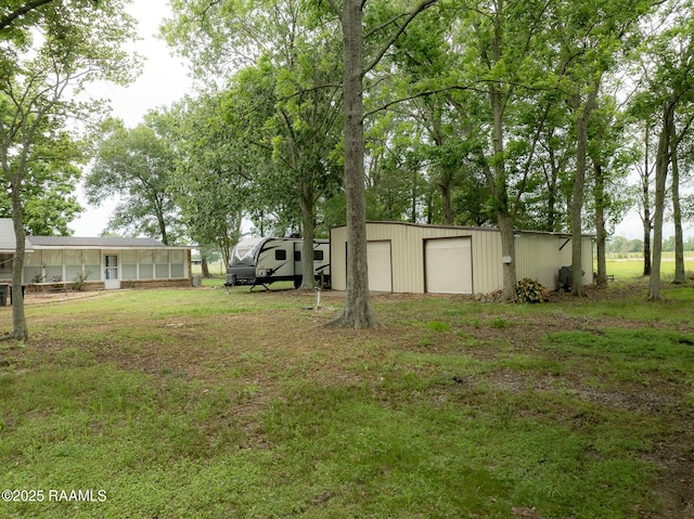 2405 S Chataignier Rd, Ville Platte, LA 70586 - view of yard featuring an outbuilding and a garage
