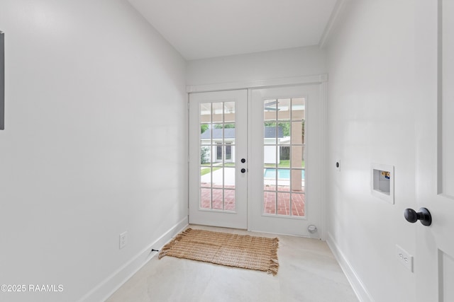 doorway featuring french doors and baseboards