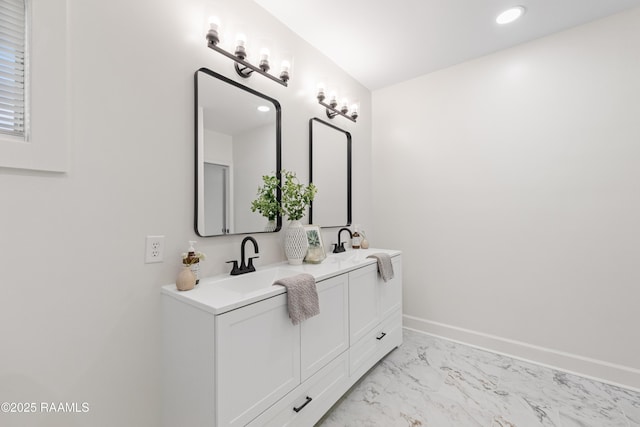 bathroom with marble look tile flooring, double vanity, baseboards, and recessed lighting