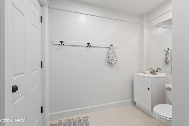 half bath featuring toilet and vanity