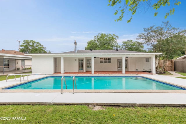 view of swimming pool with fence and a patio