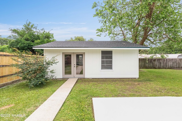 back of house with french doors, a shingled roof, and a patio area