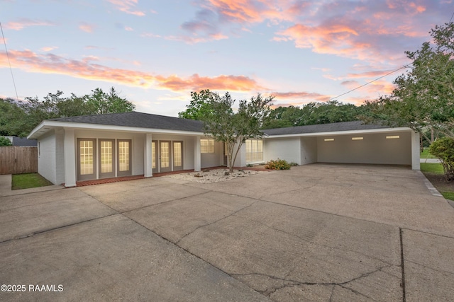view of front of house with driveway and fence