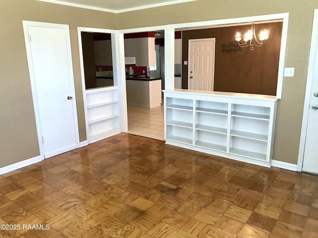 141 Emerite Dr, Lafayette, LA 70506 - spare room featuring a chandelier, baseboards, and built in shelves