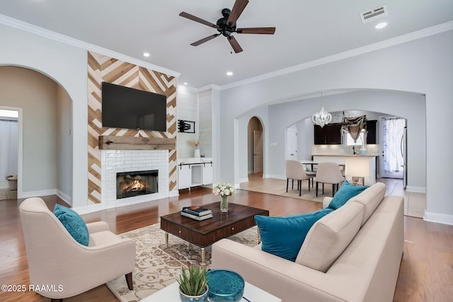 123 Laurel Grove Blvd, Youngsville, LA 70592 - living area with arched walkways, wood finished floors, recessed lighting, ceiling fan, and baseboards