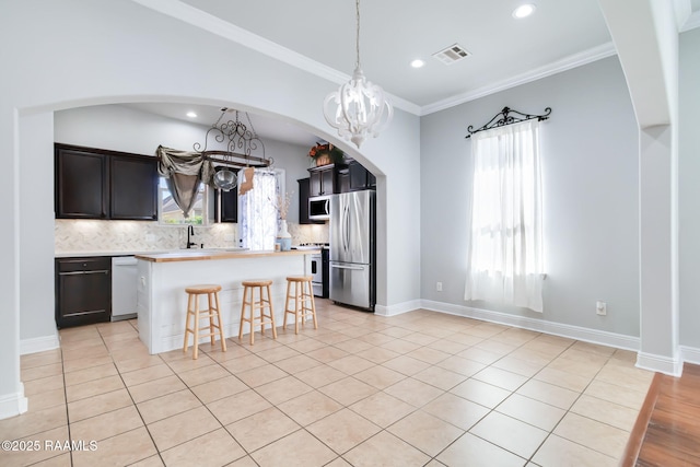 123 Laurel Grove Blvd, Youngsville, LA 70592 - kitchen featuring stainless steel appliances, backsplash, a center island, recessed lighting, and healthy amount of natural light