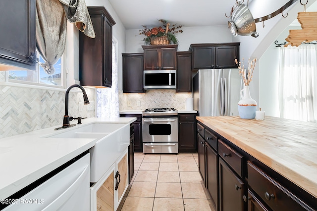 123 Laurel Grove Blvd, Youngsville, LA 70592 - kitchen featuring appliances with stainless steel finishes, butcher block counters, healthy amount of natural light, and backsplash