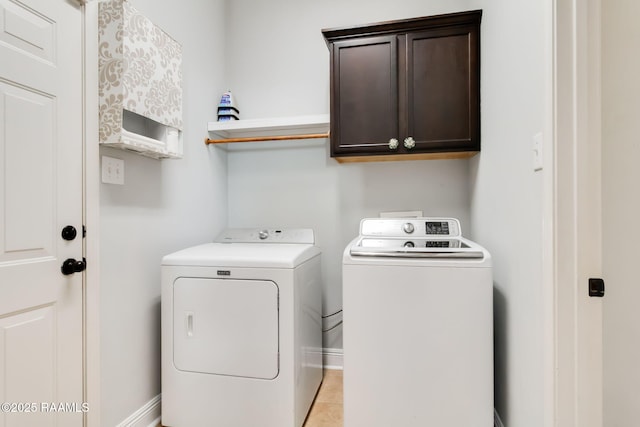 123 Laurel Grove Blvd, Youngsville, LA 70592 - washroom featuring cabinet space, separate washer and dryer, and light tile patterned flooring