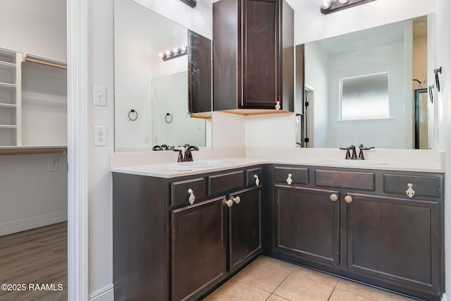 123 Laurel Grove Blvd, Youngsville, LA 70592 - bathroom with double vanity and tile patterned flooring